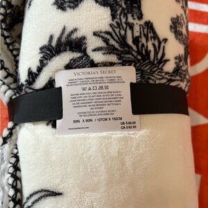 white blanket with black designs, New